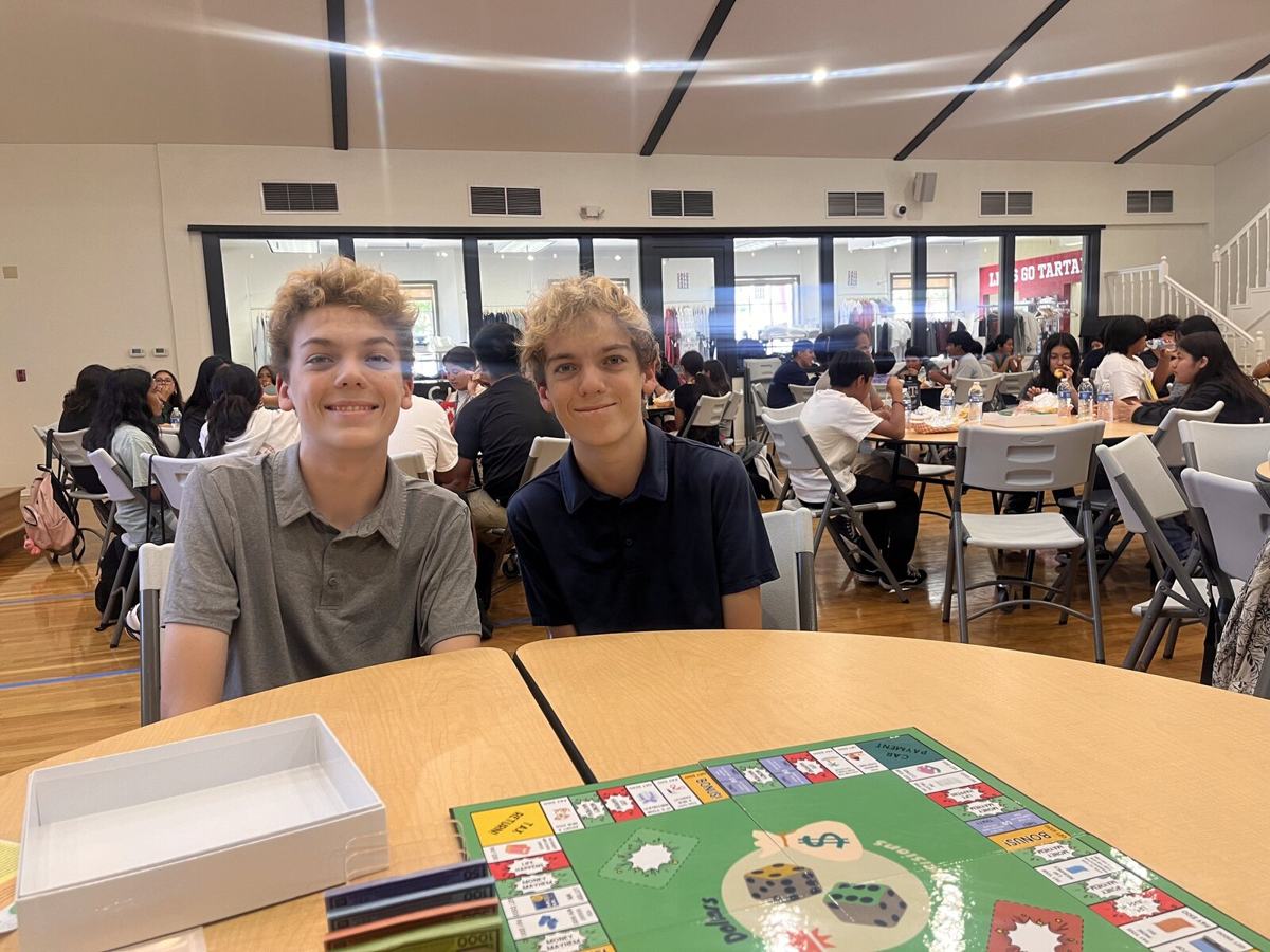 Luke and Nick smiling at a camp table before a session