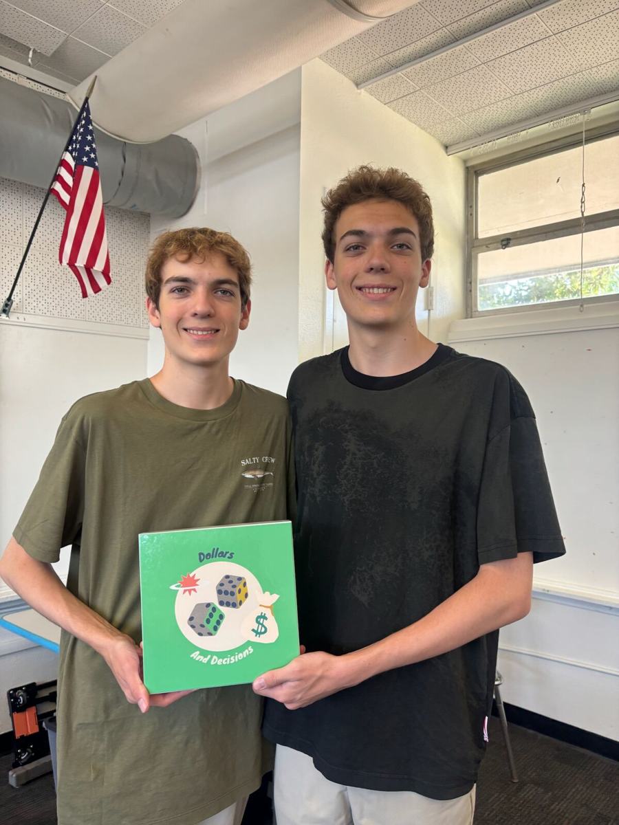 Luke and Nick holding Dollars and Decisions