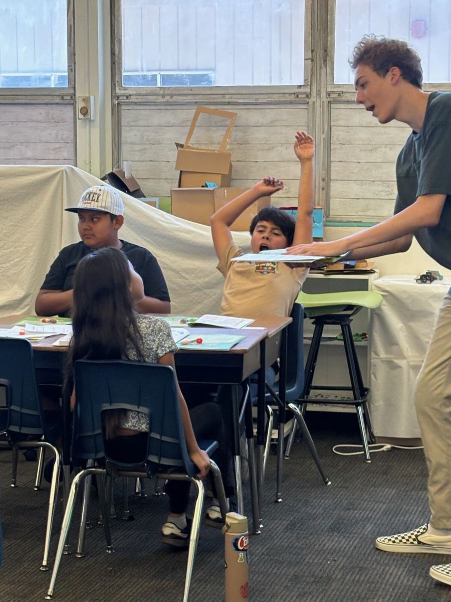 One of the founders teaching from the front of the classroom